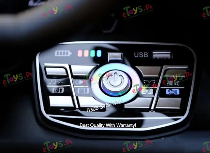 A close-up of a car dashboard control panel with a glossy black face, silver trim, and a central illuminated power-button icon. Visible text includes USB, battery indicators.