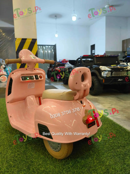 Rear view of pink Vespa-style scooter for toddler girls